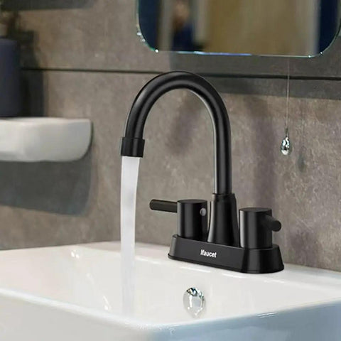 Matte Black 4 Inch Centerset 3 Hole Bathroom Faucet With Two Handles Lead Free Copper Pop Up Drain SUS304 Stainless Steel 1.2 GPM Water Saving Aerator CEC Listed Ideal For Modern Sinks installed on white basin.
