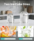 Ice cube molds, two clear dome-shaped plastic domes on a white kitchen counter.