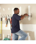 Man using Cordless Screwdriver With Forward And Reverse Switch, Manual Screw Driving Option, Built In Peg Hole, AA Battery Powered