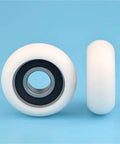Ten Pack 6202RS Circular Arc Pulleys With Plastic Coated Polyamie Nylon Bearings For Heavy Duty Machinery To Cut Rust And Reduce Friction Without Greasing Needed. Image shows white nylon pulley with black bearing.