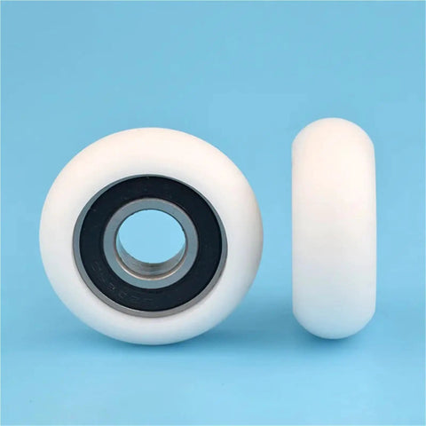 Ten Pack 6202RS Circular Arc Pulleys With Plastic Coated Polyamie Nylon Bearings For Heavy Duty Machinery To Cut Rust And Reduce Friction Without Greasing Needed. Image shows white nylon pulley with black bearing.