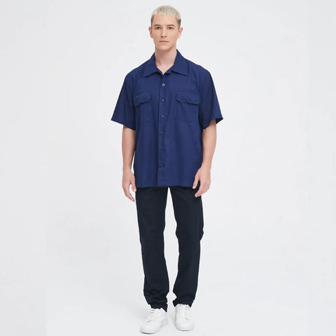 Men's Short Sleeve Work Shirt In Navy Blue Cotton Poly Blend Durable Button Front Uniform Features Double Chest Pockets Built Hella Tough For The Daily Grind And Extra Large Cut on a model standing against a plain background.