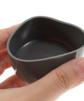 Close-up of a hand holding a Tough As Nails 4 Pack 1.98 Inch Rubber Wheel Hub Bearing Cover, showing durable rubber material.