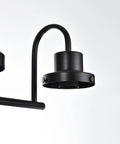 Close-up of black fixture detail on four light black vanity light fixtures with clear glass shades dope industrial wall sconces.