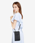 Woman carrying Small Crossbody Bag For Women With RFID Blocking Wallet And Card Slots, Phone Pouch, and zippered compartments