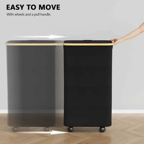 Slim Laundry Hamper With Wheels And Lid, 62L rolling clothes basket with bamboo handle, shown in motion, black.