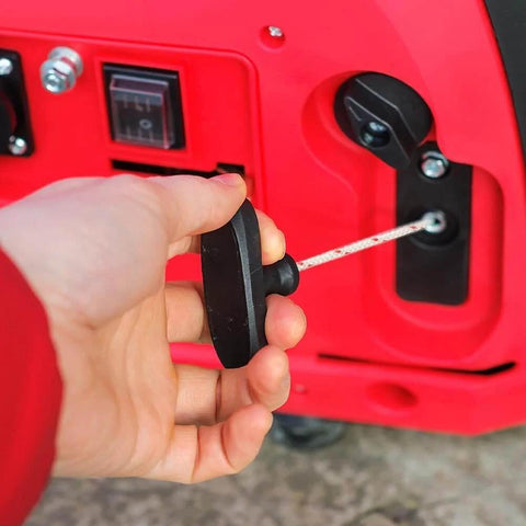 Close-up of a hand pulling the handle of a Garage Door Emergency Pull Rope Kit With Handle For Attic Ladder Access Safe Quick Operation And Durable Replacement Cord Easy Installation For Garage Doors And Attic Ladders Safety Design For Urgent Access Compact Size 2.76 X 2.17 X 0.70 Inches against a red panel.