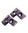 Grab These 10 Piece APMT160408 YBG205 Indexable Carbide Lathe Tools that Rock On Steel And Stainless For Serious Machining Action, close-up of three carbide inserts.