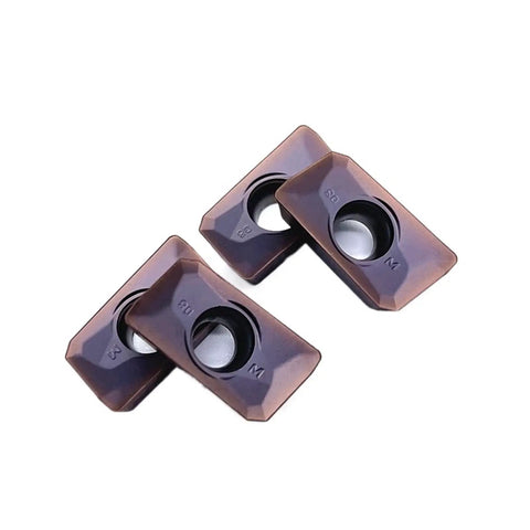 Grab These 10 Piece APMT160408 YBG205 Indexable Carbide Lathe Tools that Rock On Steel And Stainless For Serious Machining Action, close-up of three carbide inserts.