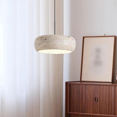 Modern Dome Yellow Travertine Pendant Light, Nordic Natural Stone Hanging Lamp above a wooden cabinet in bright room.