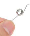 Close-up of a stainless steel torsional spring, part of the 4 Pieces Heavy Duty Metal Torsional Spring Parts For Trash Can Lid Replacement