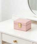 Rock Solid Lockable Metal Box Latches Gold Surface Mount Snap Fasteners With Spring Loaded Toggle Catches For Secure Wooden Jewelry Case Storage And Craft Gear on a pink box.