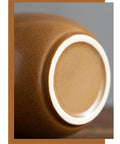 Close-up of the base of a vintage Chinese ceramic tea canister, showcasing its smooth finish and airtight seal. Keep Your Stash Locked Tight And Crisp With This Vintage Chinese Ceramic Tea Canister Airtight Kitchen Storage Jar Perfect For Coffee Beans Spices And Seasonings Dishwasher Safe.
