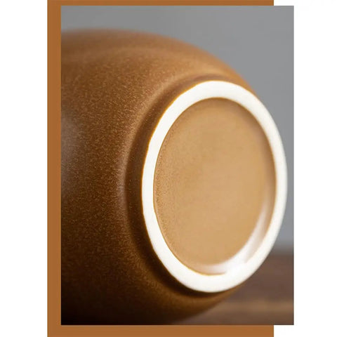 Close-up of a solid glazed ceramic tea canister with airtight Ruyi lid for stashing premium ground coffee beans.