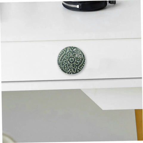 Single ceramic drawer pull in celadon blue with vintage pattern on a white dresser from Set Of 10 Ceramic Drawer Pulls And Kitchen Cupboard Knobs.