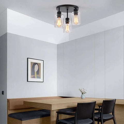Three Light Industrial Farmhouse Black Matte Ceiling Light Fixture With Clear Glass Shades Semi Flush Mount in modern dining area.