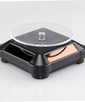 Solar Powered Rotating Jewelry Display Stand With Built In Kickstand, sleek ABS turntable riser for collectibles.