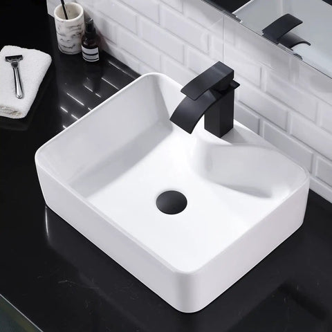 White Vessel Sink With Gold Faucet And Drain, 18x13 Inch Above-Counter Rectangle Ceramic Porcelain Bathroom Basin on black counter