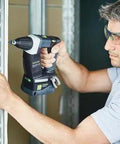 Man using Hardcore No Fuss Cordless Construction Screwdriver With Brushless Motor Tech on metal framing in a job site.