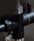 Super Tough 3 Way Shower Diverter Valve With Solid Brass Build And Seamless 1 Inlet To 2 Outlet Switching Featuring No Sweat Removable Nut Setup Plus Dependable Rubber Gaskets That Stay Leak Free And Make Bathroom Upgrades A Breeze For Everyone close-up of black brass shower diverter valve with integrated rubber gasket.