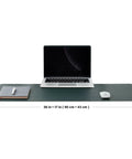 Dual Sided Desk Mat With Eco Friendly Cork And PU Leather Surface For Office And Home Large 90 Cm By 43 Cm Desk Pad Perfect For A Big Mouse Pad And A Slick Desk Setup Dark Green with laptop and accessories on top.