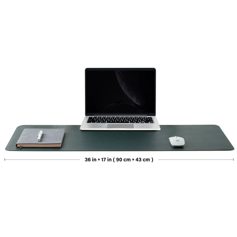 Dual Sided Desk Mat With Eco Friendly Cork And PU Leather Surface For Office And Home Large 90 Cm By 43 Cm Desk Pad Perfect For A Big Mouse Pad And A Slick Desk Setup Dark Green with laptop and accessories on top.