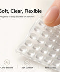 Close-up of soft clear silicone cabinet door bumpers, showing flexible rubber pads for cabinets and drawers.