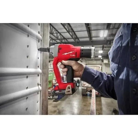 Quarter Inch Cordless Blind Riveter For Milwaukee M18 Fuel Platform in use, fastening metal sheets with precision.