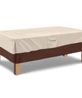 Heavy Duty Waterproof Rectangular Outdoor Patio Coffee Table Cover With Padded Handles And Durable Hem Cord Fits Large Rectangular Tables 600D Oxford Fabric UV Stabilized Beige And Brown covering a wooden table