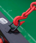 Close-up of red chain and hook on Hay Bale Spear Frame Attachment For Universal Front Loader Buckets Heavy Duty Skid Steer Loader 3000 Lb