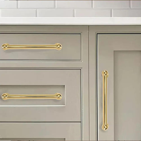 Close-up of polished brass drawer handles installed on gray kitchen cabinets, showcasing the 10 Pack 10 Inch Center To Center Cabinet Pulls Rock Solid Heavy Duty Polished Brass Drawer Handles No Nonsense Build For Kitchen Cabinets Dressers And Bathroom Remodels Killer Shine Finish.