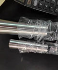 Two silver Morse taper adapters in plastic wrap; reducing drill sleeves for lathes and drill presses.