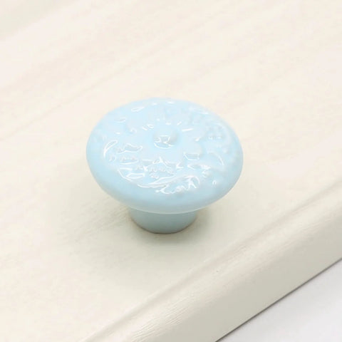 Light blue ceramic mushroom cabinet knob from the 15 Piece Ceramic Mushroom Cabinet Knob Set With 3 Size Mounting Screws Glossy Vintage Dresser Drawer Cupboard Pulls For Furniture DIY Wardrobe Solid Color Hardware Easy Install Durable Alloy Core on a white surface