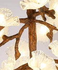Close-up of Tree Branch Ceiling Pendant Light Straight Up Fresh Statement Chandelier with clear flower shades and brown branch design.