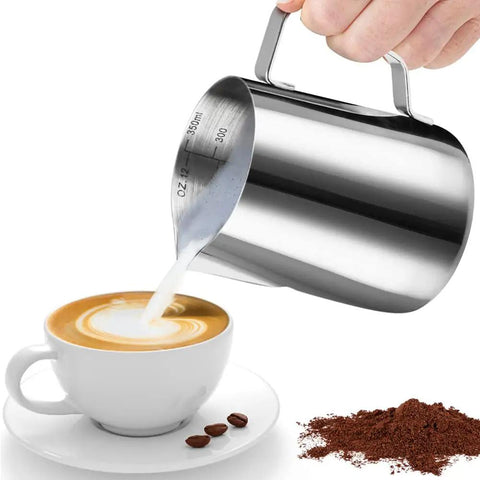 Hand pouring milk from Stainless Steel Milk Frothing Pitcher For Latte Art 12 Ounce Barista Grade Pouring Jug into coffee cup