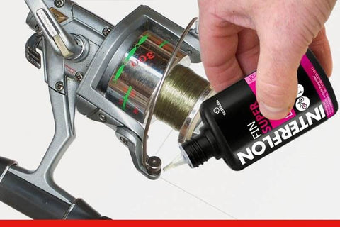 Hand applying Multipurpose Dry Film Lubricant With Long Lasting Penetrating Action For Indoor And Outdoor Use 50ml to fishing reel