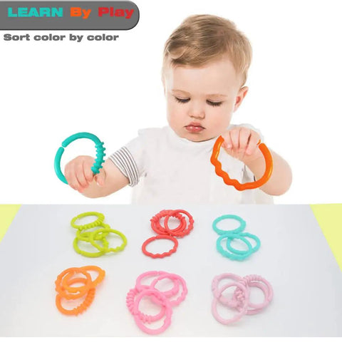 Child playing with 24 Pack Baby Link Rings Set For Hanging Toys On Crib Rail Car Seat And Stroller Travel With Storage Box.