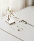 Compact Mini Machine Bench Drill Press For Tiny Spaces Precision Micro Electric Power Tool with tools on white table.