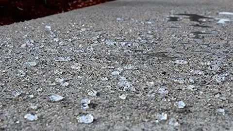 Heavy Duty Five Gallon Concrete Sealer With Water Based Siliconate Formula For No Sweat Salt And Water Repellency Against Cracking Pool Damage showing water beads on protected concrete surface.