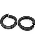 Close-up of two black steel spring washers from Beefy DIN127 GB93 Black Grade Eight Point Eight Steel Spring Washer Set M2 Through M24 Split Lock Elastic Gasket For Mechanical Fastening Corrosion Resistant Lock Washers Multi Size Kit.