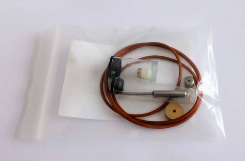 Front view of pneumatic valve repair kit in clear bag; orange hose coiled with metal probe.