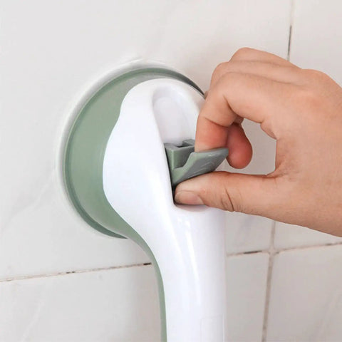 Hand adjusting a wall-mounted grab bar with suction cup attachment