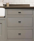 Hella Sleek Matte Black T Pull Cabinet Knobs 1.5 Inch Horizontal Handles For Kitchen Cabinets on gray cabinetry with drawers.