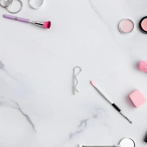 Awesome Premium 8 Piece Stainless Steel R Cotter Pins For Industrial Mechanical Assembly on a marble background with makeup tools.