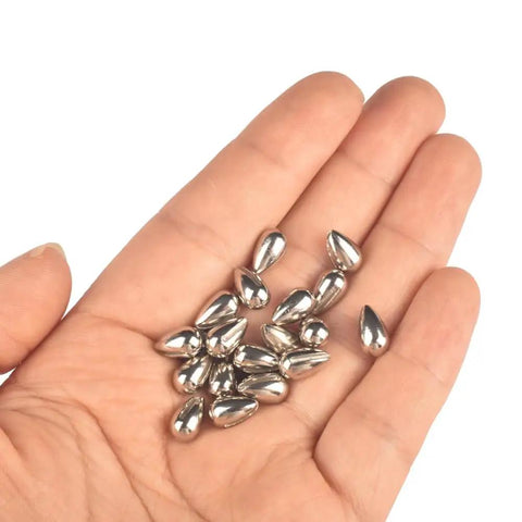 Killer 20 Pack Tungsten Teardrop Jig Heads Without Hooks, Heavy 97 Percent Alloy DIY Welding Bodies Sweet For Ice Fishing, Unpainted 4mm, held in a hand.