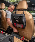 Man in car with Auto Boss Cable Bag For Jumper Cables And Cords, 600 Denier Ripstop Water Resistant Fabric, attached behind seat