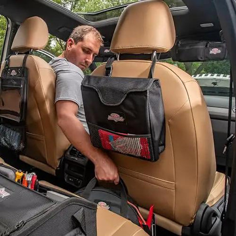 Man in car with Auto Boss Cable Bag For Jumper Cables And Cords, 600 Denier Ripstop Water Resistant Fabric, attached behind seat