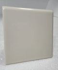 Close-up of Beige Bone Almond Ceramic Bullnose Tile 4x4 Square Trim With Curved Edge 9 Piece Box Classic Color 006 on display