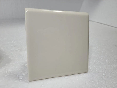 Close-up of Beige Bone Almond Ceramic Bullnose Tile 4x4 Square Trim With Curved Edge 9 Piece Box Classic Color 006 on display