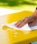 350 Count White Heavy-Duty Shop Towels, Ultra Absorbent Industrial Wipers, wiping water from a yellow surface